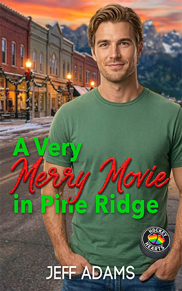 Book cover for A Very Merry Movie in Pine Ridge by Jeff Adams. A smiling blond man in a green T-shirt stands in a small-town street decorated with holiday lights and garland, backed by a sunset sky and distant mountains.